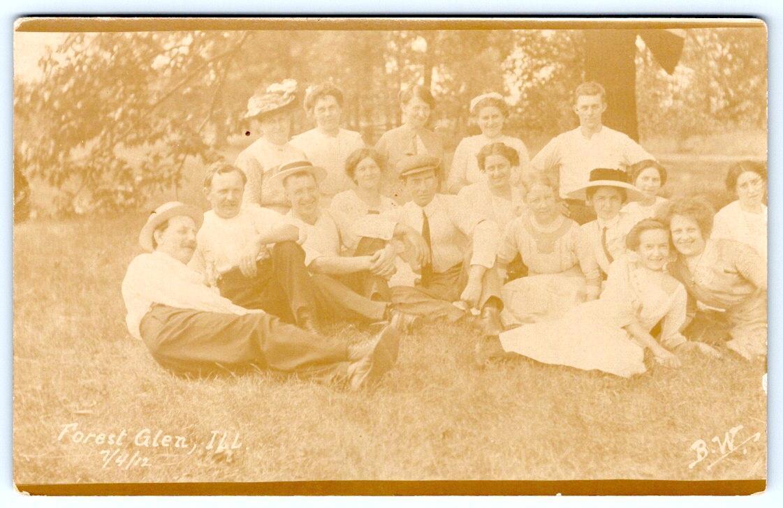 1912 4th of JULY RPPC FOREST GLEN ILLINOIS GROUP PHOTO*PHOTOGRAPHER B.W.*PICNIC?