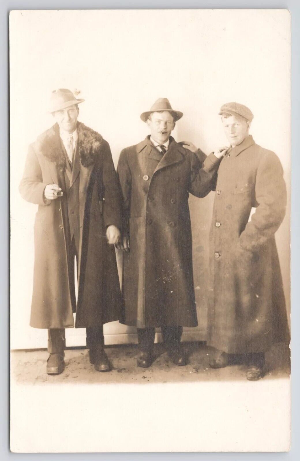 RPPC Three Men In Overcoats with Cigars Clasping Shouldes c1910 Photo Postcard