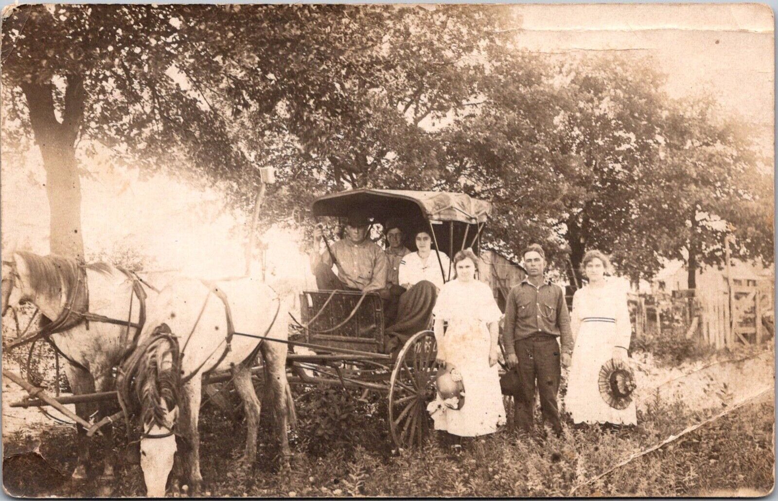 RPPC Two women with hats horse drawn covered buggy three people inside names