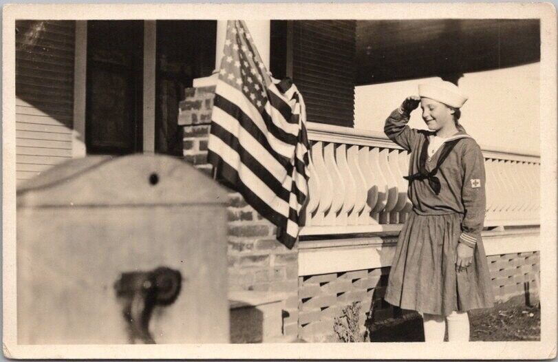 1910s WWI Photo RPPC Postcard Girl in Red Cross / Sailor Outfit Saluting US Flag