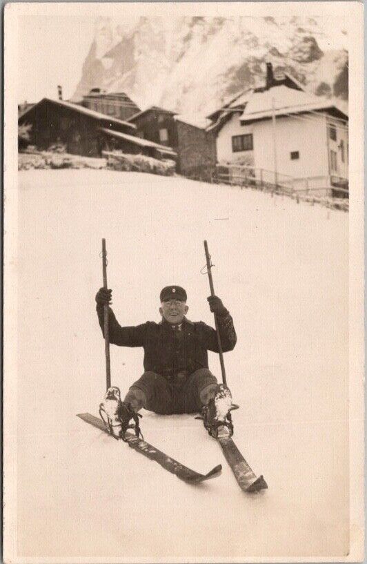 Vintage European SKIING Photo RPPC Postcard Happy Smiling Man Sitting on Butt