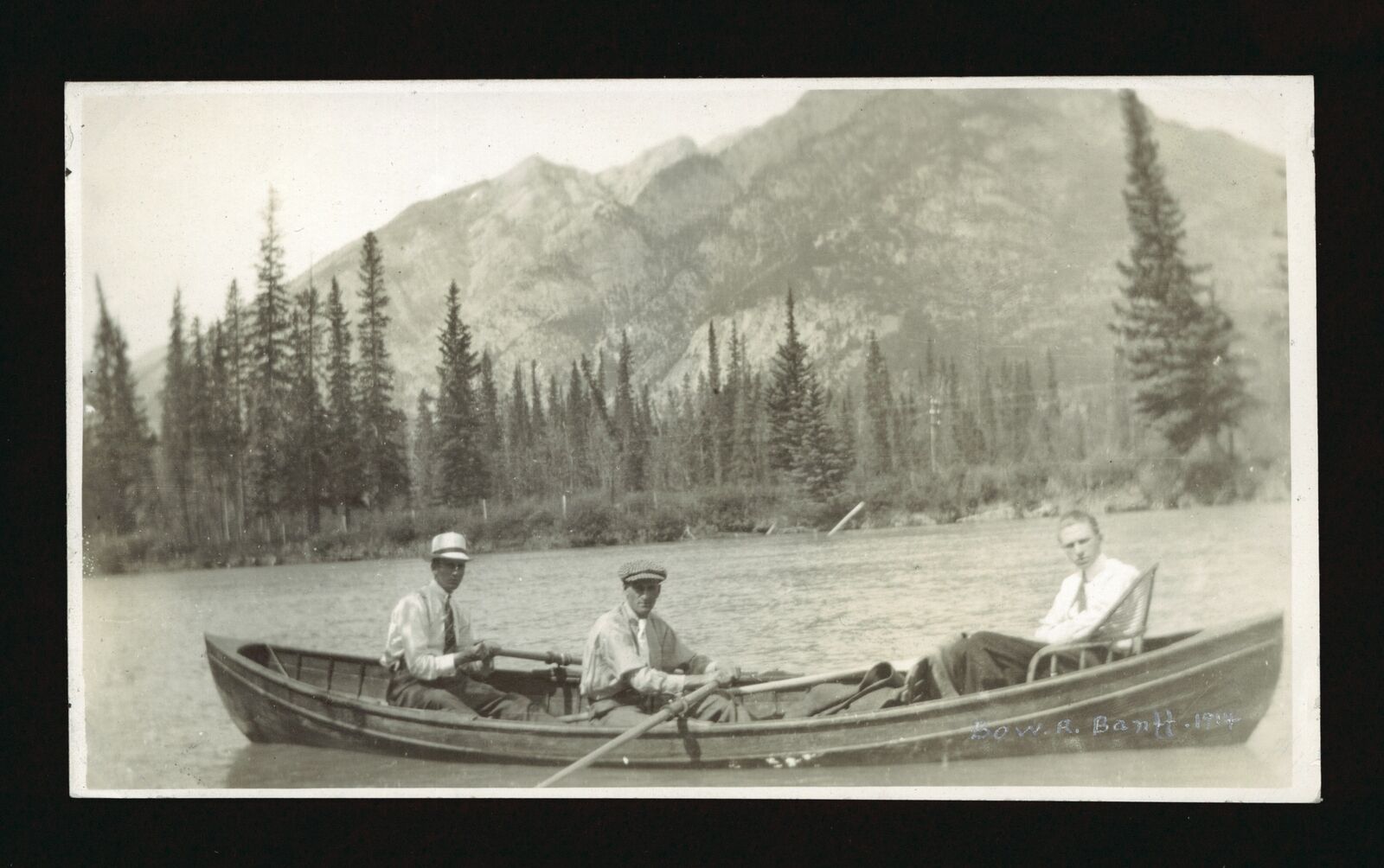 Bow R Banff 1914 - showing three men in a canoe on the Bow River Old Photo
