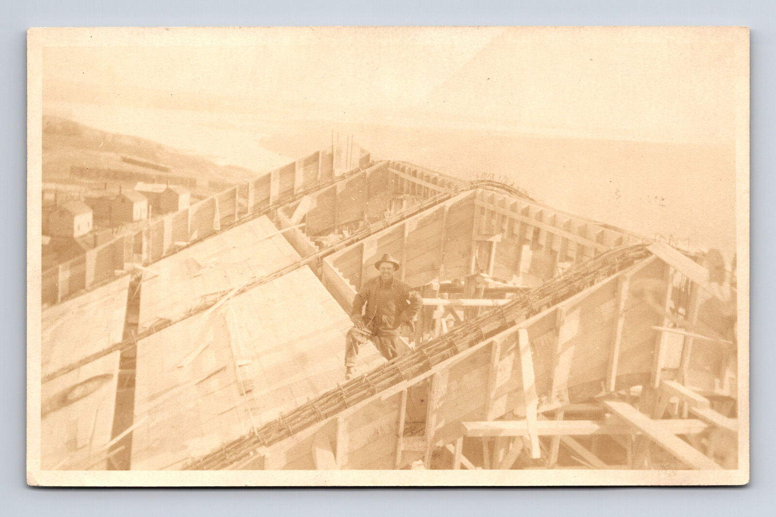 RPPC Roofer Worker Man Posing For Photo Large Building by Sea Postcard