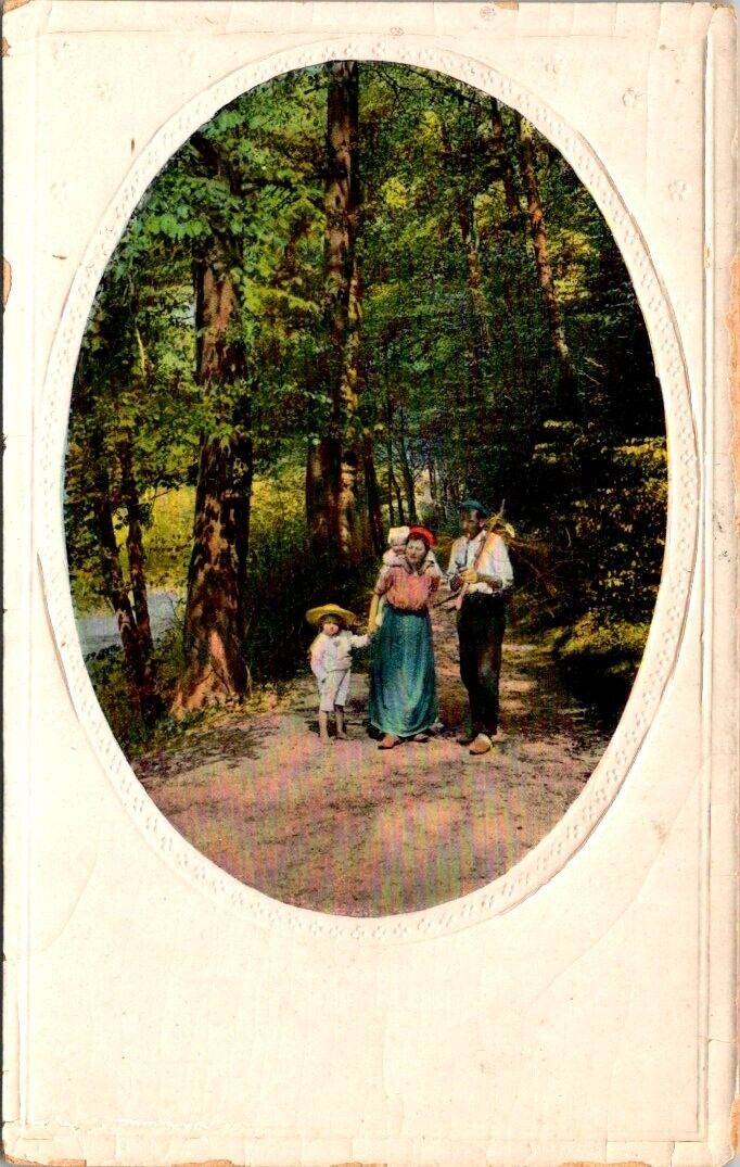 vintage postcard- Family walking along path in the woods c1900s unposted embos.