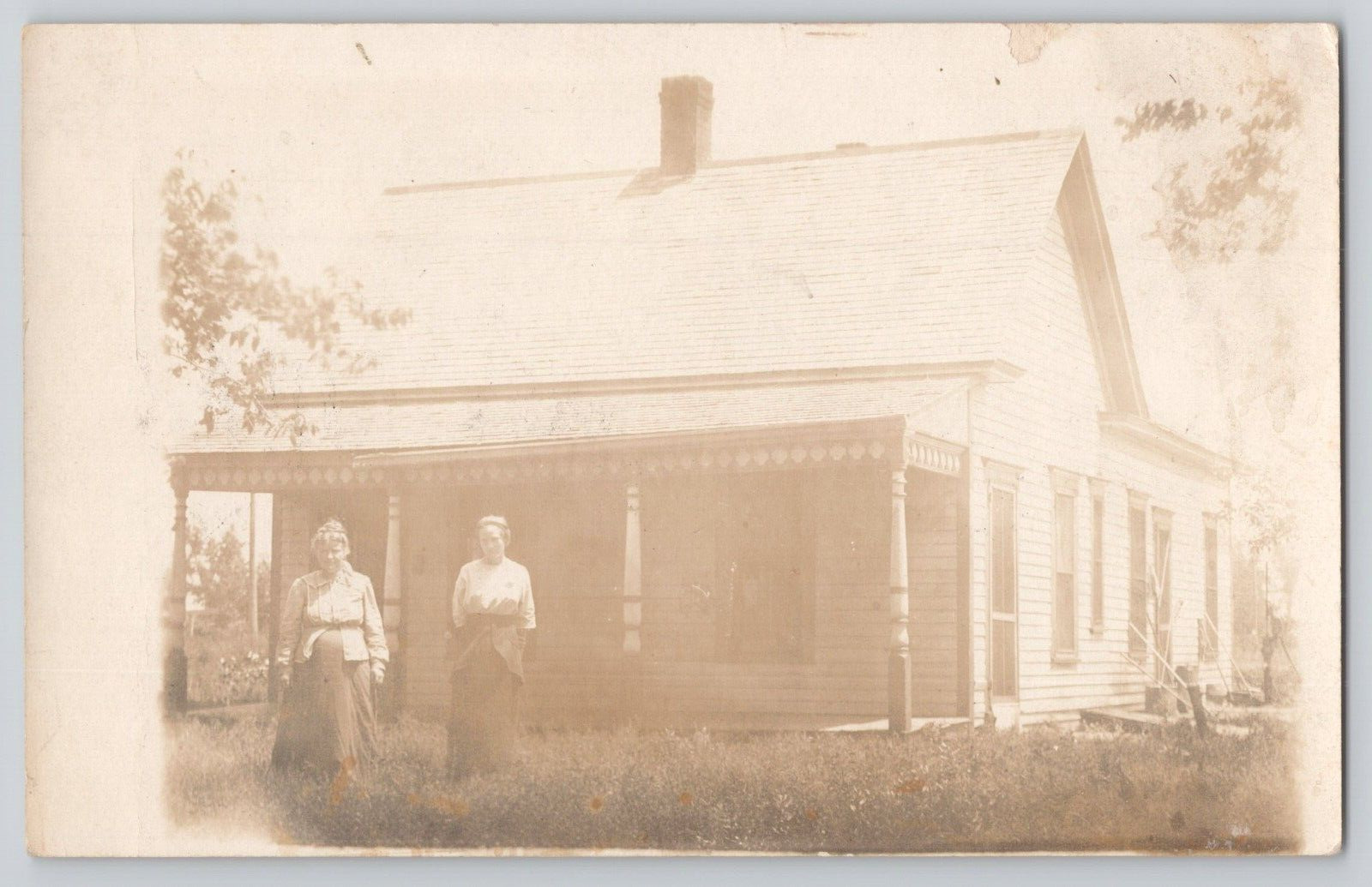 Postcard Rppc 2 women at a homestead, c1915