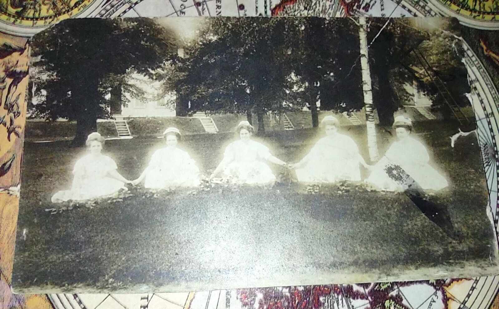 RARE SPOOKY AND EERIE RPPC OF FIVE GHOSTLY LOOKING WOMEN HOLDING HANDS ON LAWN.
