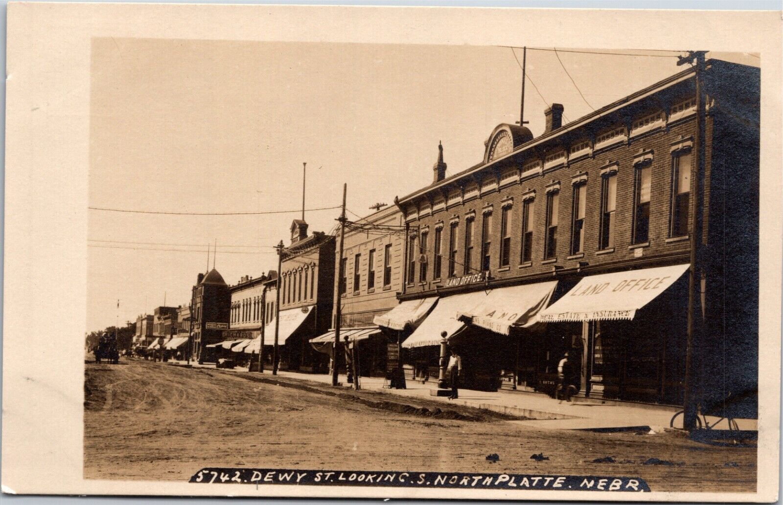 RPPC North Platte NE Nebraska Dewy St Looking S LAND OFFICE etc Vintage Postcard