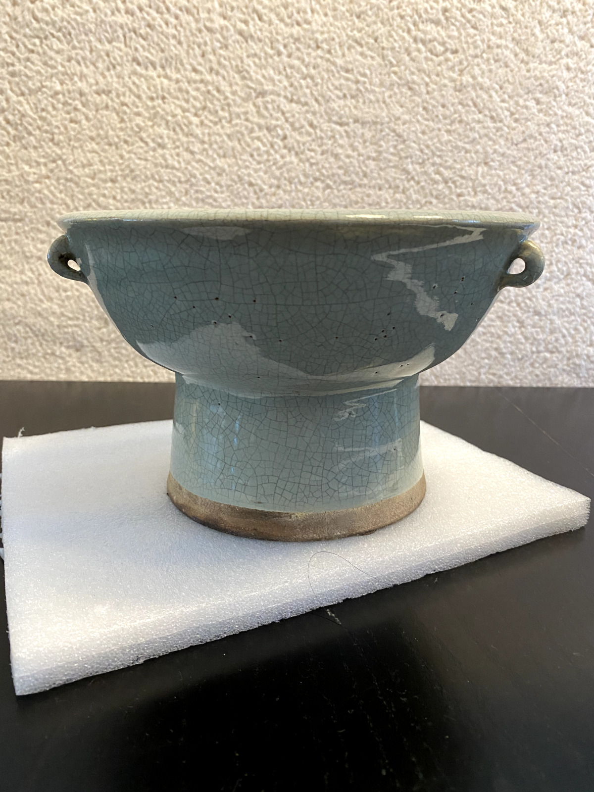 A Chinese porcelain celadon long-stemmed bowl with 2 ears