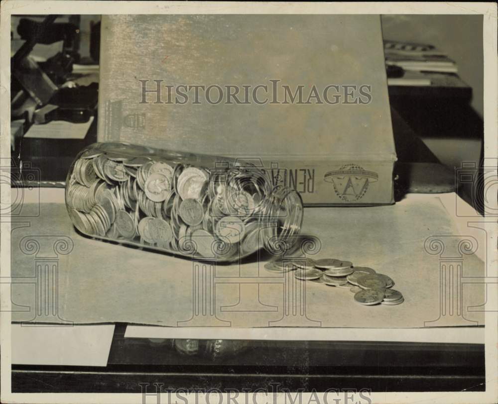 1964 Press Photo Glass jar full of coins - lra59128