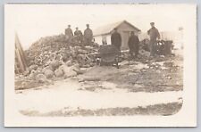 Men Standing on Woodpile Cutting Logs Large Saw Winter Scene Snow RPPC Postcard picture