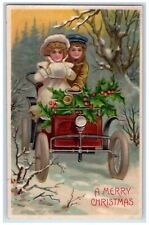 c1910's Christmas Boy Girl Driving Car Handwarmer Holly Embossed Posted Postcard picture