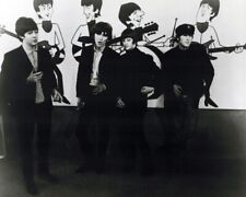 The Beatles pose in front of their cartoon animated characters 8x10 inch photo picture