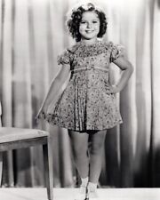 Shirley Temple hand on hip smiling standing by chair 8x10 inch photo picture
