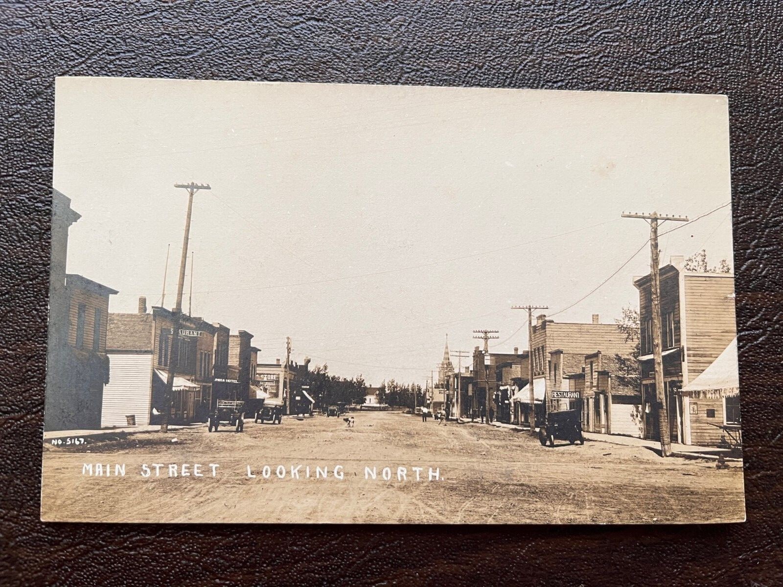 RPPC Oregon Street Scene Columbia Hotel Coos Merc. Co. early 1900s