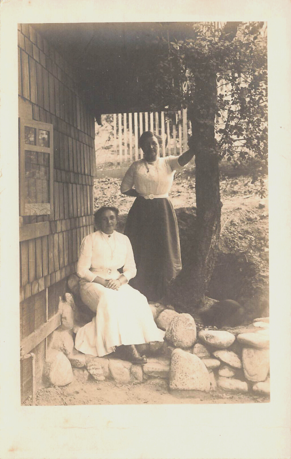 TWO WOMAN OUTSIDE ON ROCKS BY HOUSE PORTRAIT REAL PHOTO POSTCARD 1910s RPPC