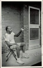 1985 Press Photo John C. Suber Sits on His Porch, Piedmont Courts Apartments, NC picture
