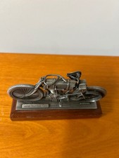 pewter replica of the Harley-Davidson Serial Number One motorcycle mounted on a  picture