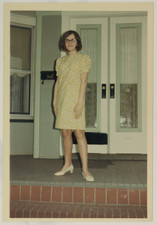 FOUND PHOTO - Young Cute brunette woman in yellow dress posing on porch 1971 picture