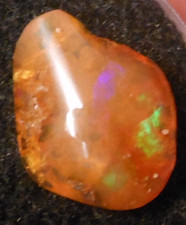 4.60ct Orange Mexican Fire Opal Blazing Greens and Purples 16mm x 12.6mm x 5.2mm picture