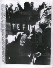 Press Photo Soldier aids a Hungarian refugee as others look on in Austria picture
